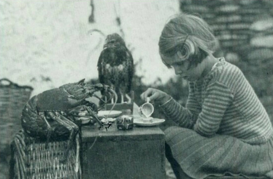 This little girl having a tea party with a lobster and a hawk in 1938